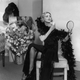 “ A woman sensationally dressed in a feather boa and beaded gown applies her make-up in a scene from ‘Gay Love’ at the Lyric Theatre, London,” 1933.